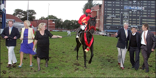 The Apache being led in by breeders Joyce and Robin Scott of Highdown Stud, with ex-trainer Gavin Van Zyl. The Apache had just claimed victory in the Grade 1 Champions Cup in July 2011. Image: Gold Circle